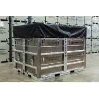 Large metal crate with black cover in warehouse.