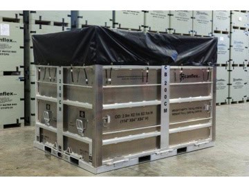 Large metal crate with black cover in warehouse.