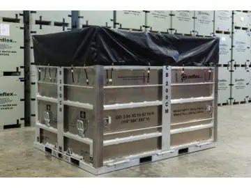 Large metal crate with black cover in warehouse.