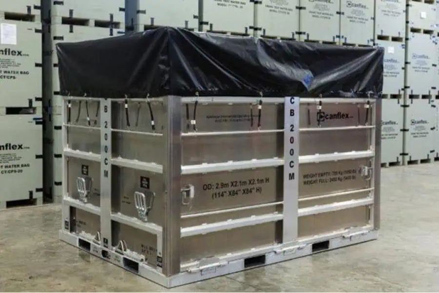 Large metal crate with black cover in warehouse.