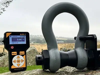 Digital load shackle displayed on stone surface