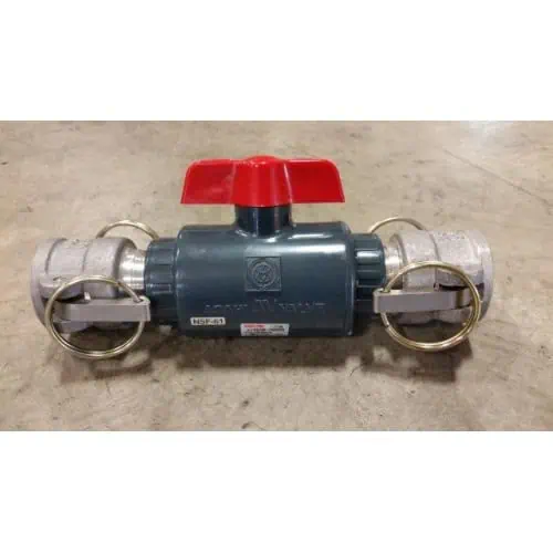 Industrial valve with red handle on concrete floor.