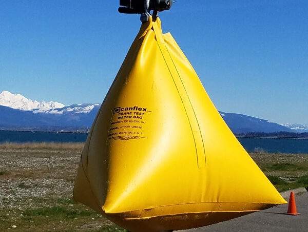 Yellow water weight bag for crane testing outdoors.