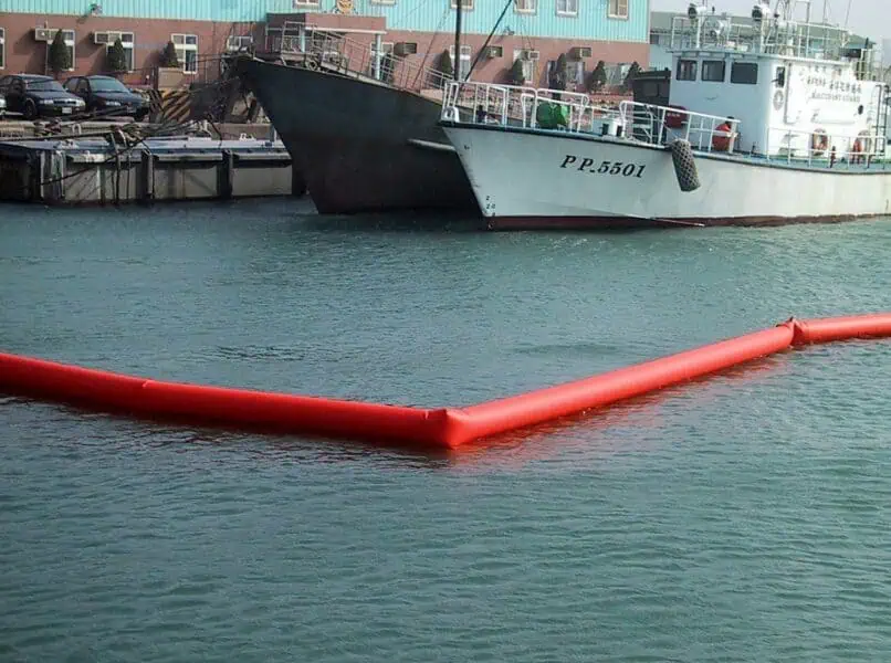 Red boom barrier in harbor