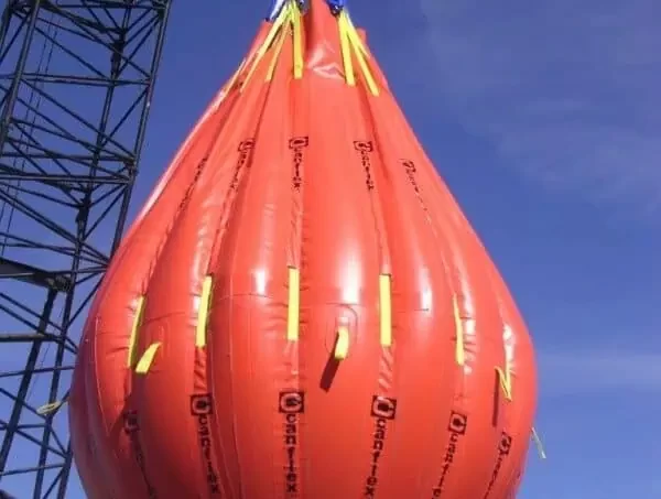 Large orange crane test water weight bag