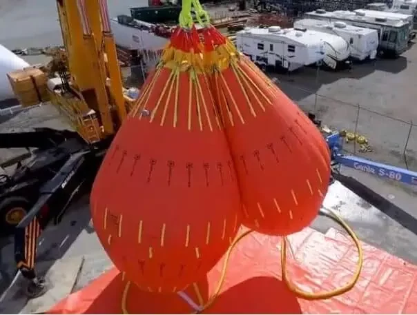 Large orange lifting bags at construction site