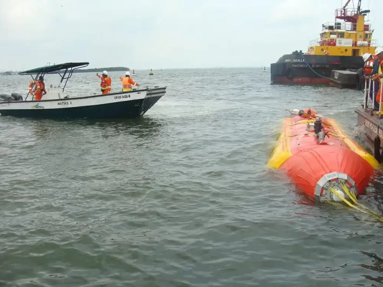 Boats and crew working on an orange vessel