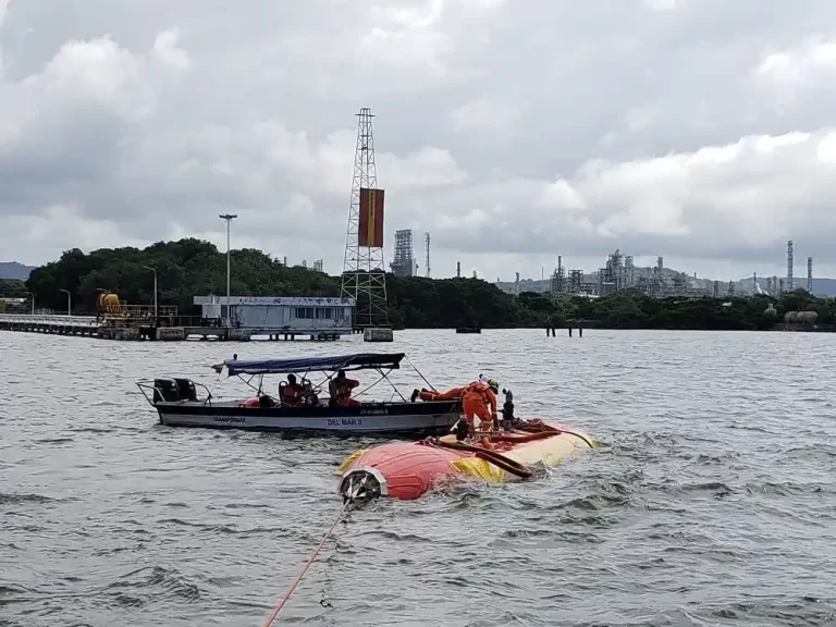 Rescue operation on overturned boat in the water.