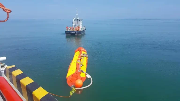 Rescue boat with life raft in ocean