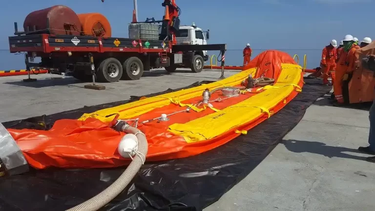 Inflatable lifeboat preparation on deck with crew.