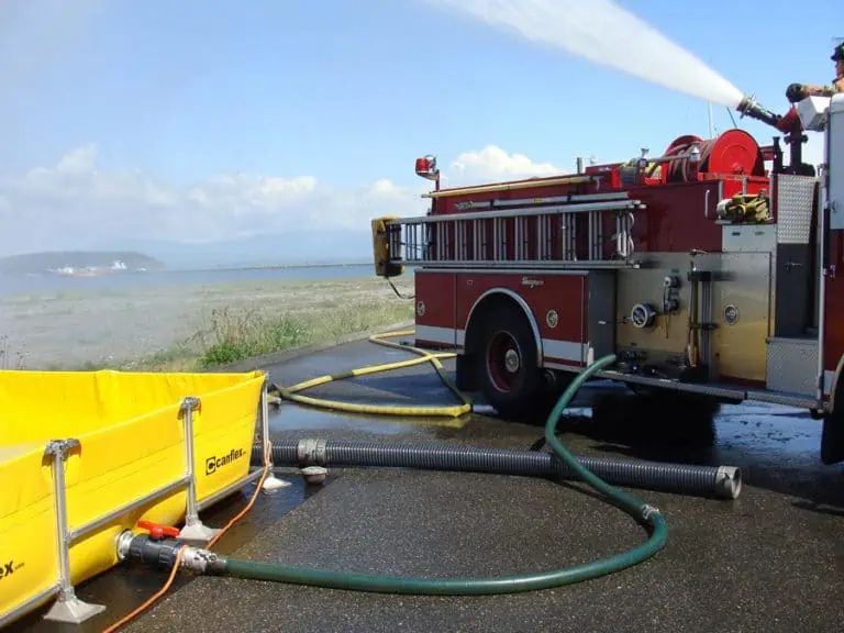 Fire truck pumping water on a coastline