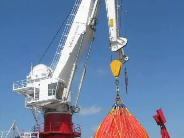 Crane moving large bundle of cables