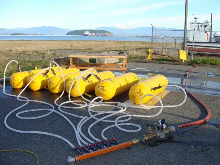 Yellow flotation devices with hoses on the dock