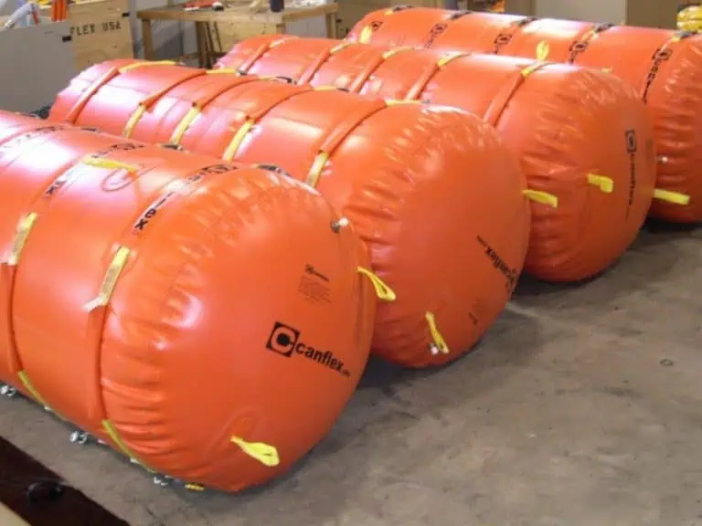 Large orange inflatable lifting bags in warehouse