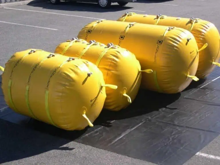 Yellow inflatable lift bags on pavement