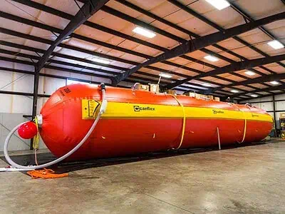 Large red Canflex tank in warehouse.