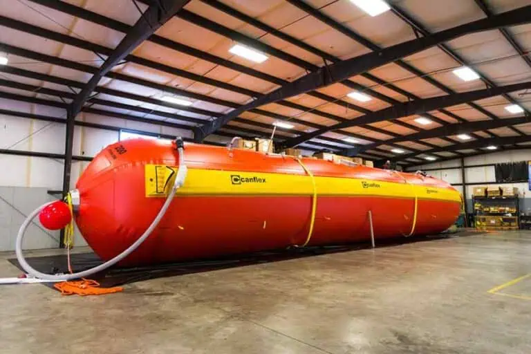 Large red Canflex tank in warehouse.