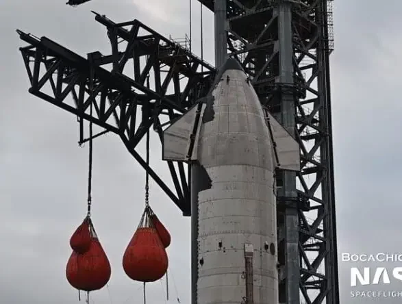 SpaceX Starship on launch pad with crane test water bags