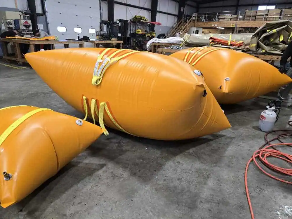 Large orange inflatable lift bags in workshop