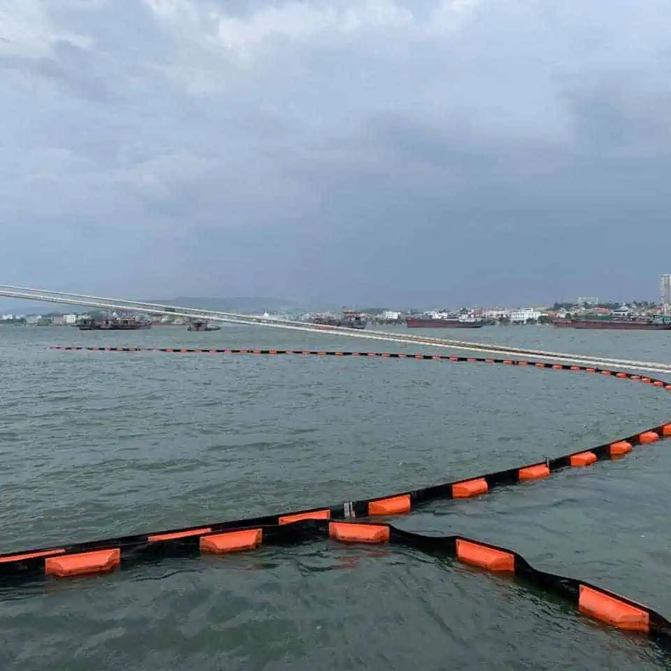 Floating barrier on water near coastal city