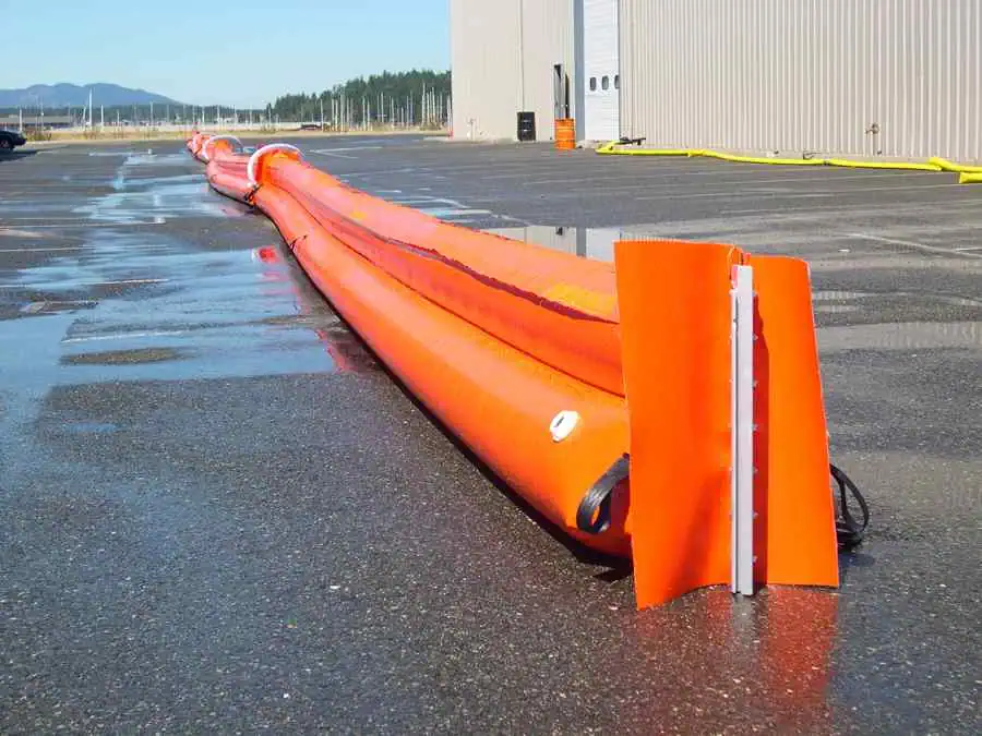 Orange water barrier on wet pavement