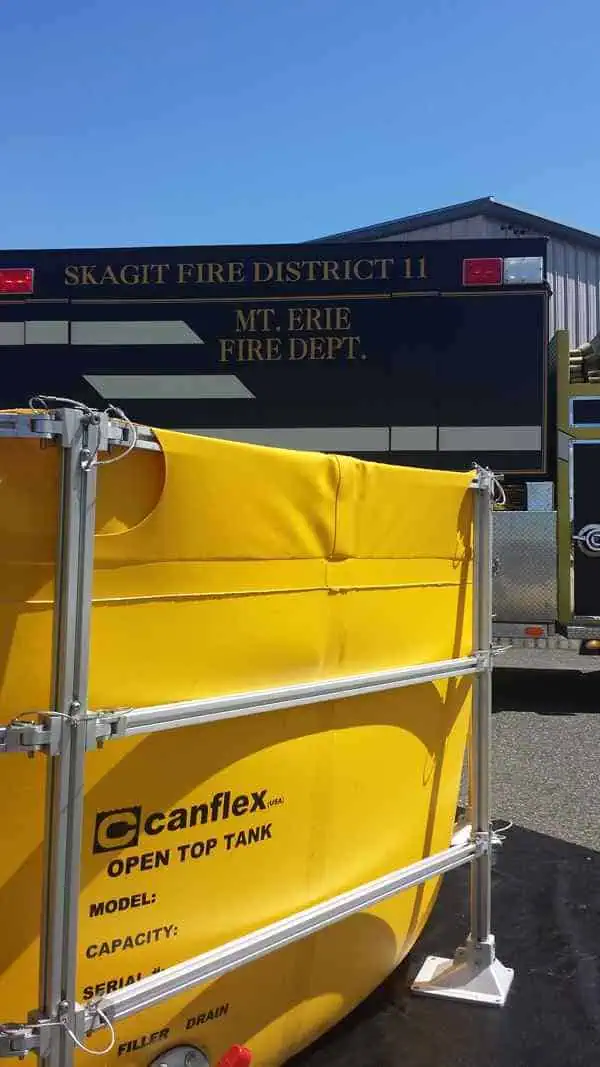 Fire truck and yellow open top water tank