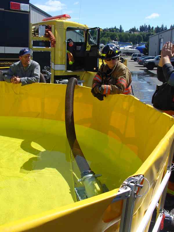 Firefighters training with portable water tank