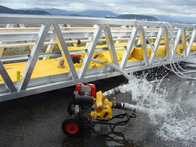 Water pump spraying near metal bridge structure