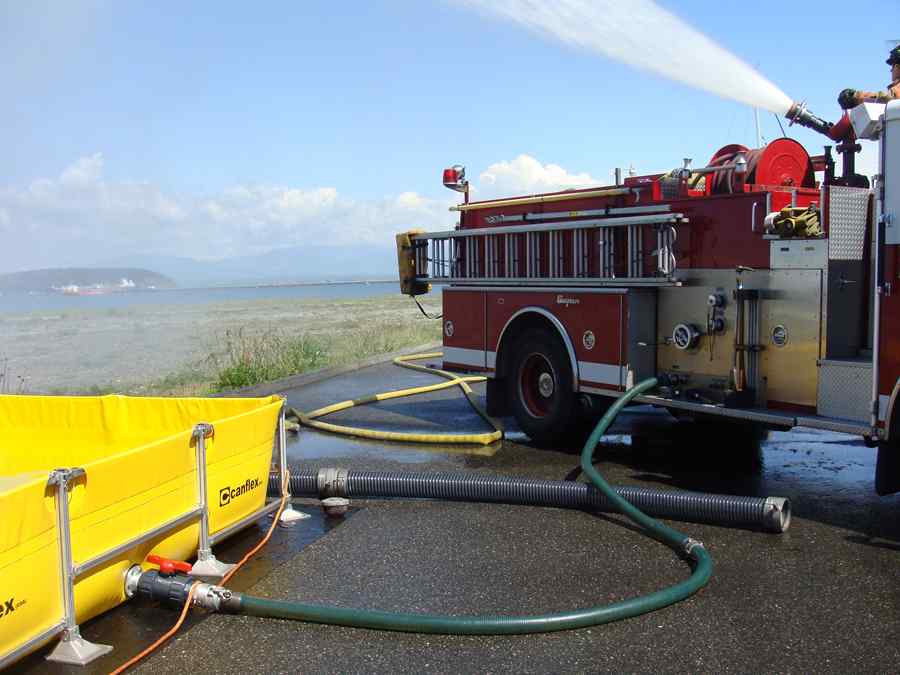 Fire truck pumping water near a beach