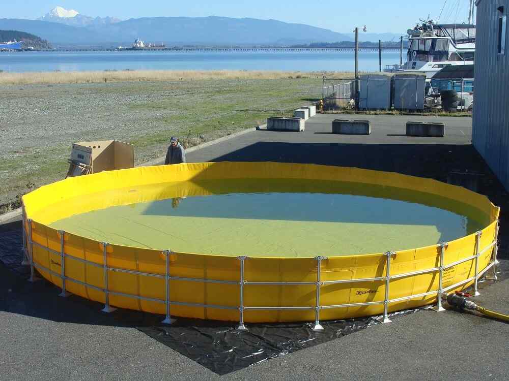 Large yellow portable water tank near harbor