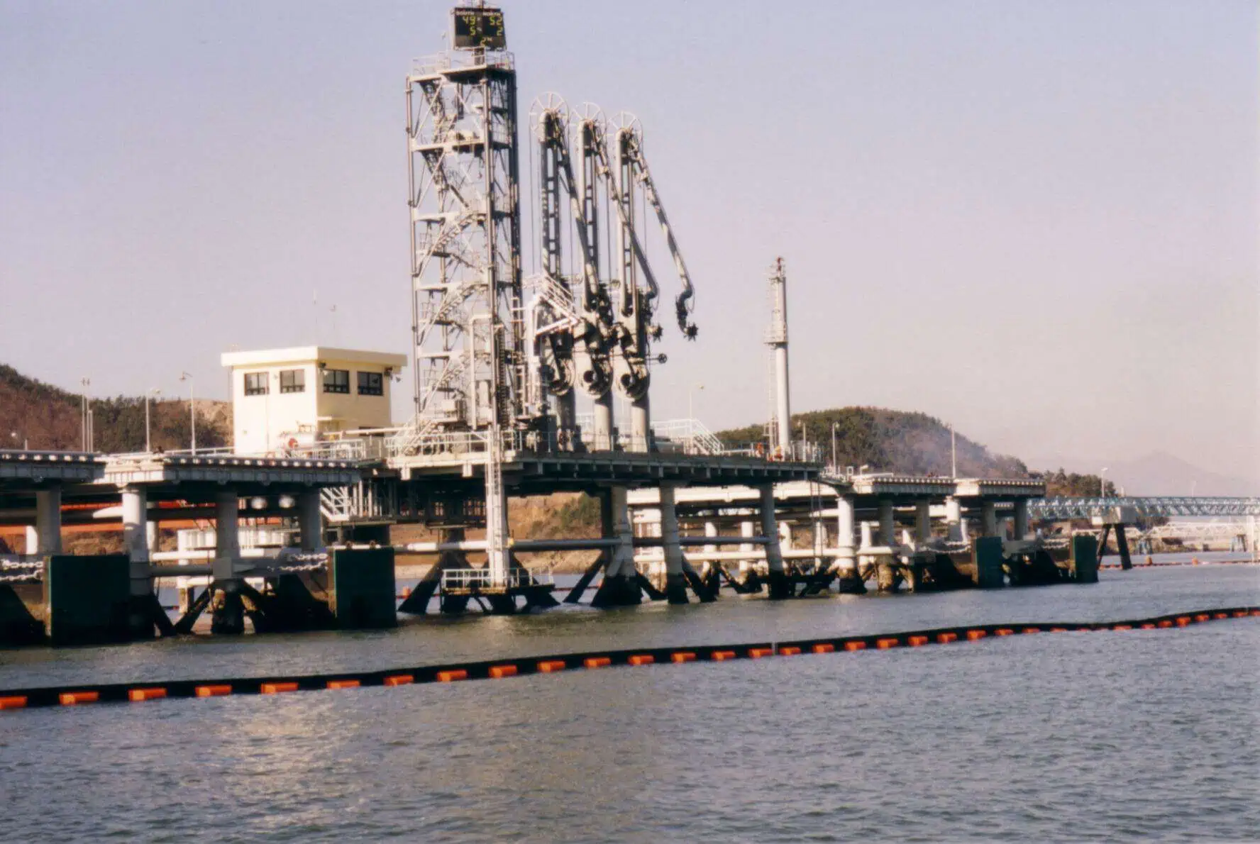 Industrial marine oil terminal with loading arms