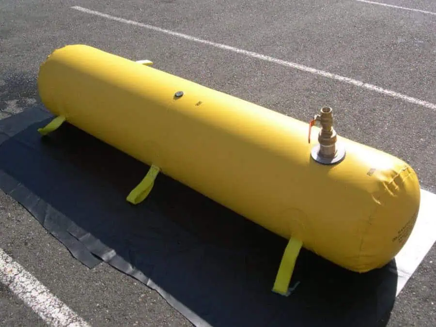 Large yellow inflatable water tank on pavement