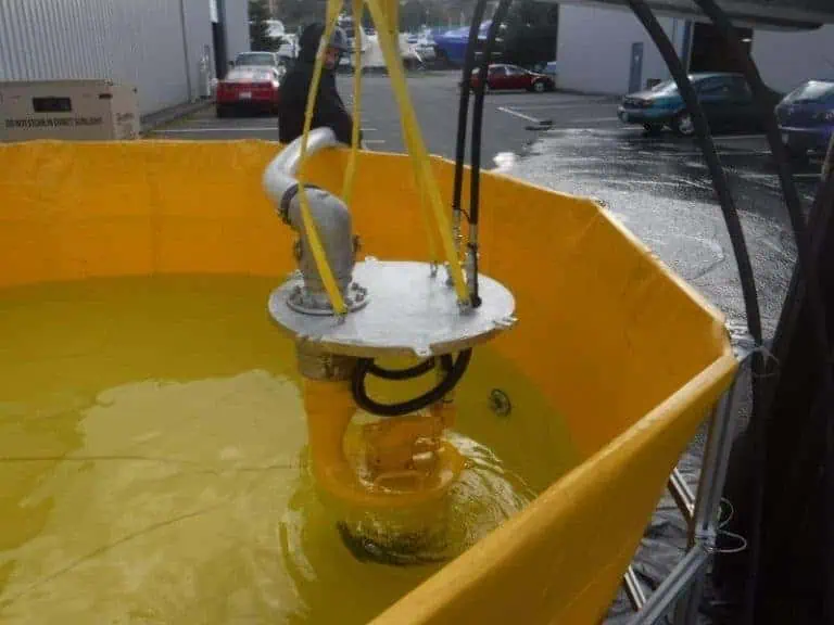 Industrial pump submerged in yellow test tank