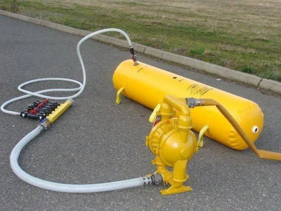 Yellow air compressor tank with hoses attached