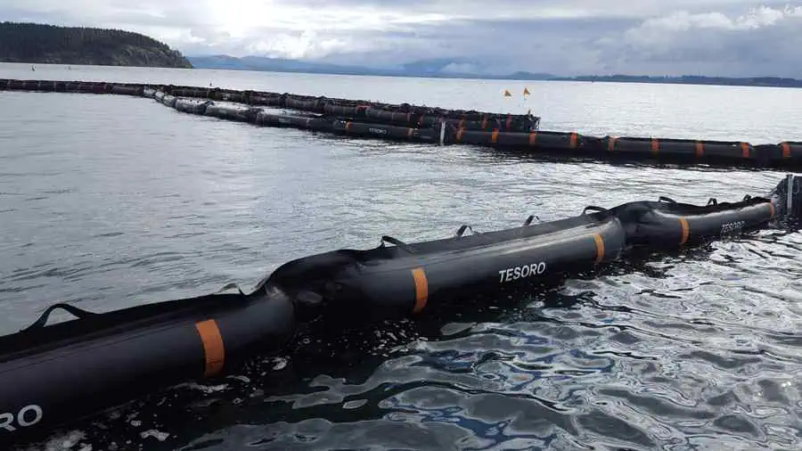 Oil containment booms floating on calm ocean water