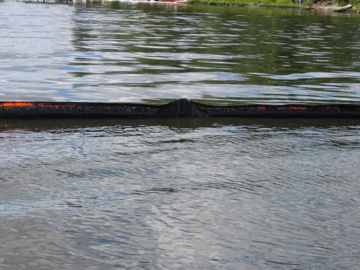 Oil spill containment boom on water surface