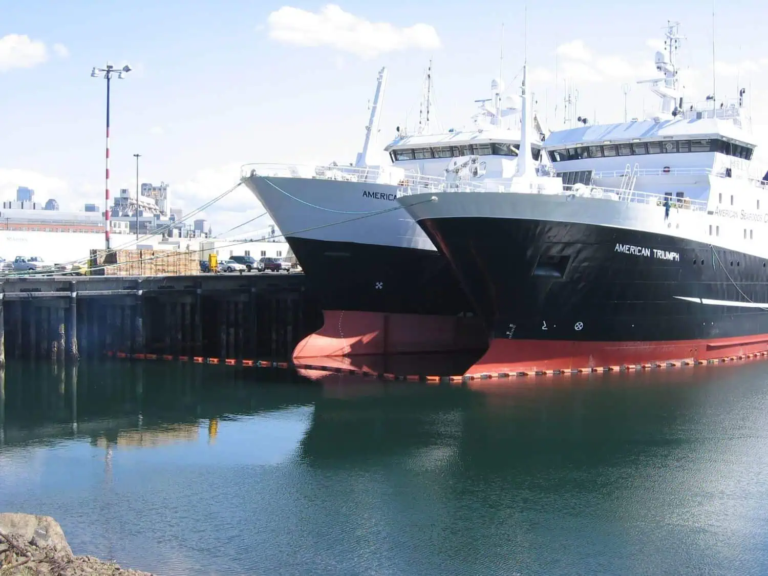 Large fishing vessels docked at a harbor