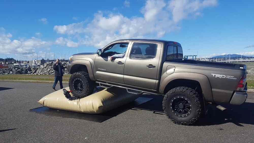 Truck driving over inflated airbag during off-road test