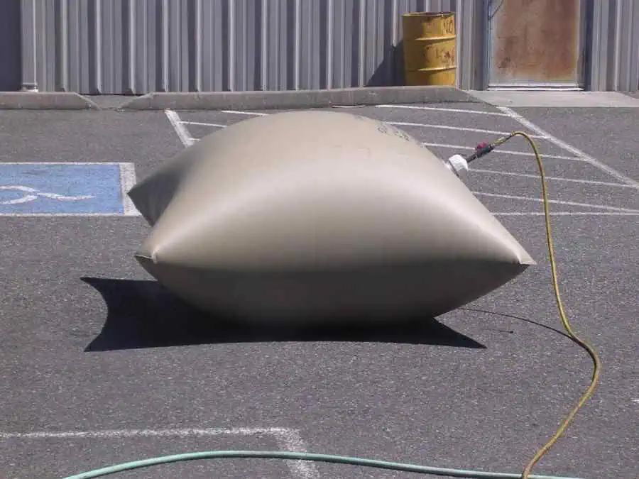 Inflated water bladder tank in parking lot