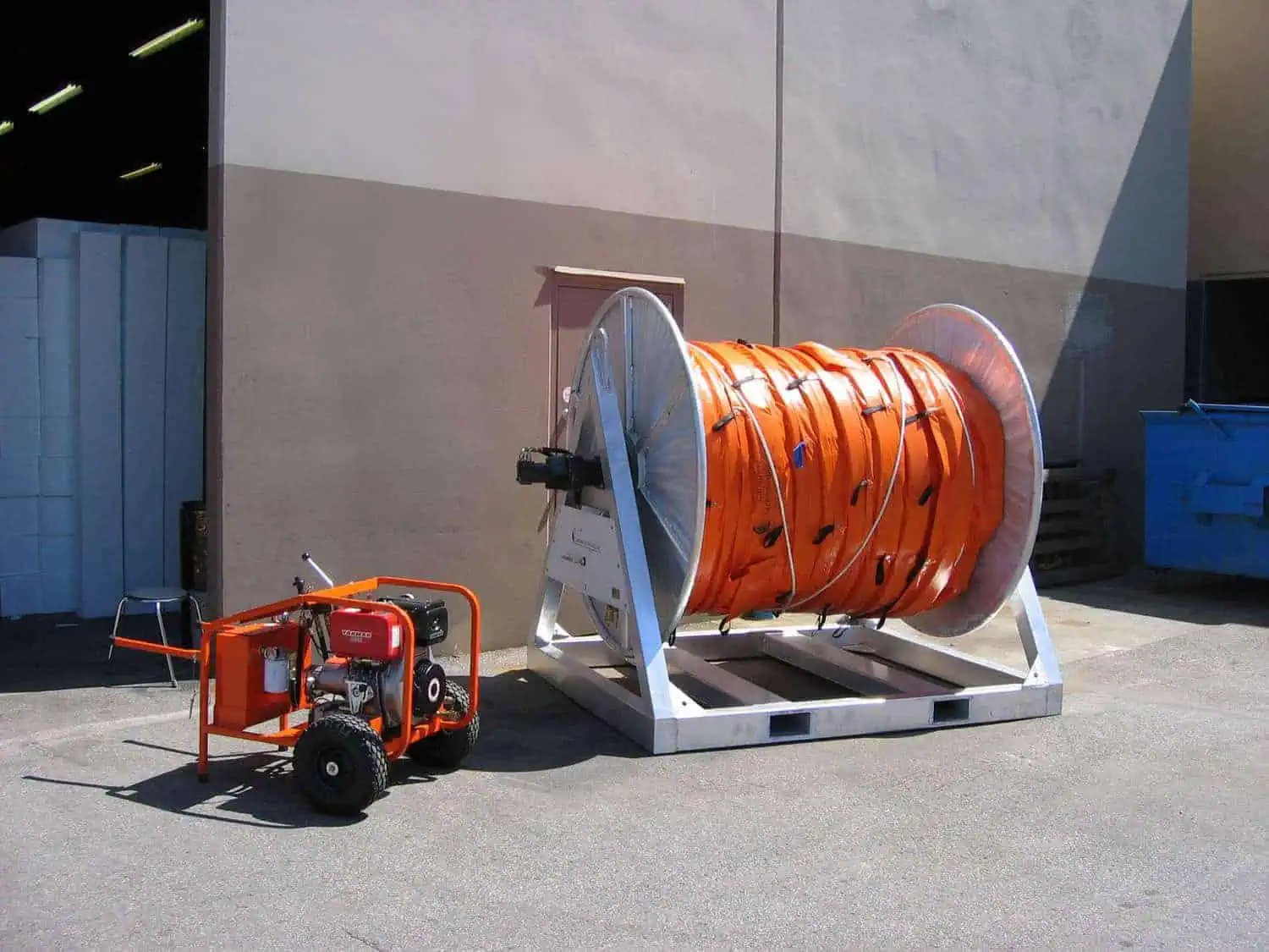 Large industrial hose reel with generator outdoors