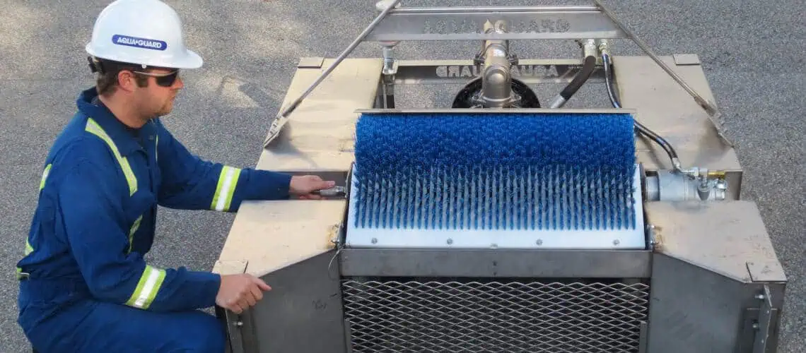 Worker operating industrial cleaning brush machine