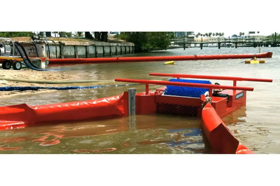 Floating barrier and skimmer cleaning polluted waterway