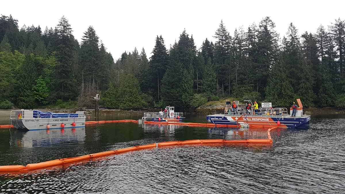 Boats conducting oil spill response on a lake