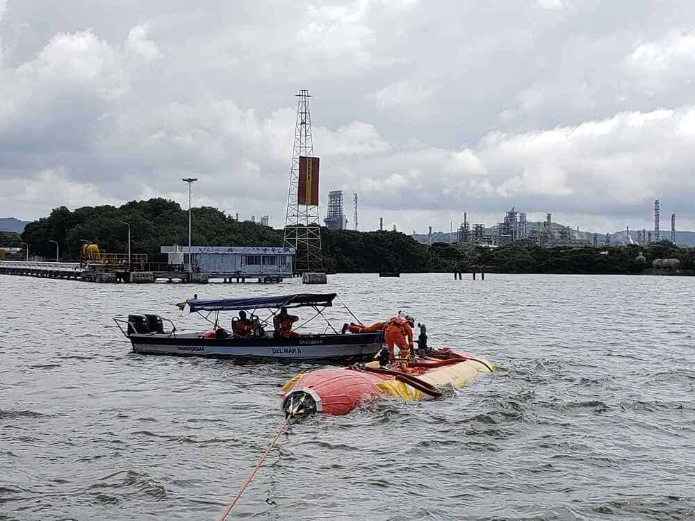 Rescue team working near capsized boat in water