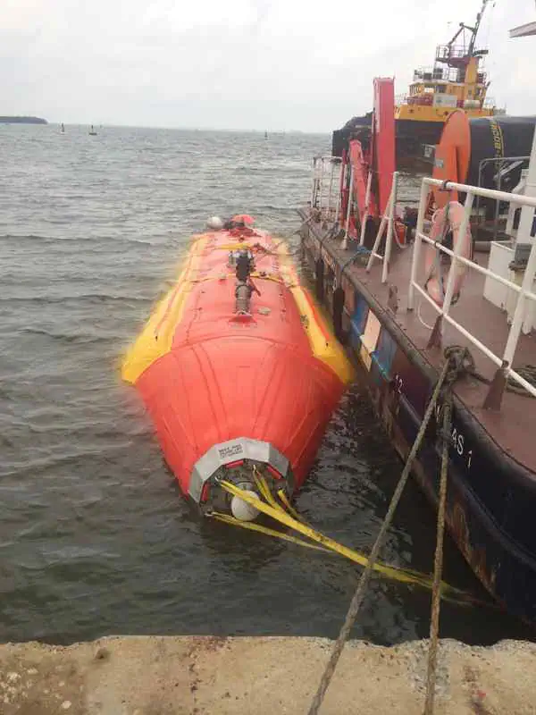 Orange lifeboat secured beside docked vessel