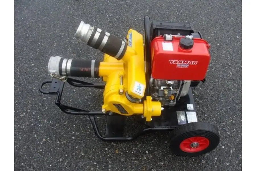 Portable Yanmar water pump on asphalt surface