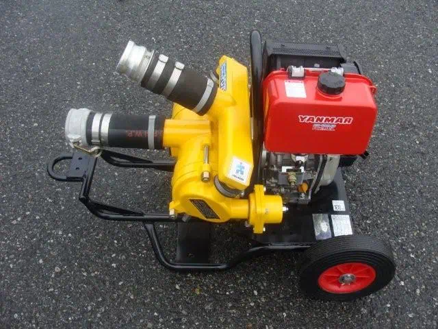 Portable Yanmar water pump on asphalt surface