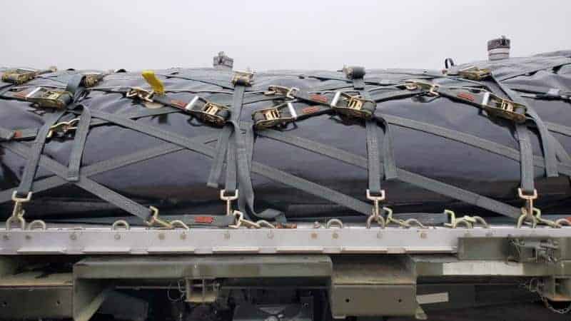 Cargo secured with heavy-duty straps on transport platform