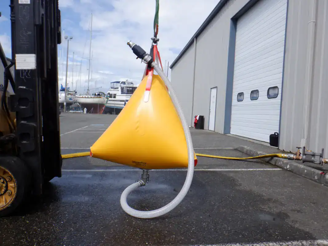 Yellow flexible fuel tank being filled outdoors