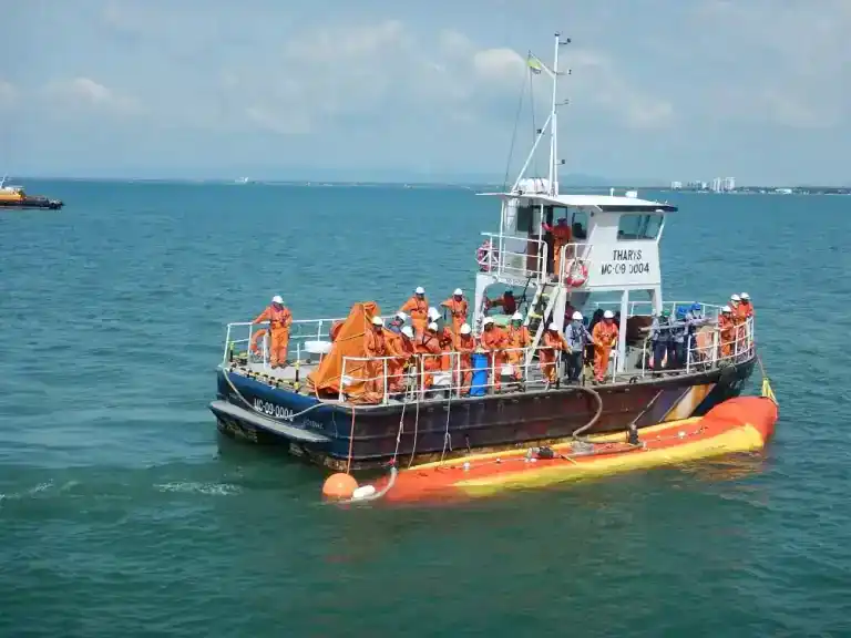 Crew practices marine safety drill on boat